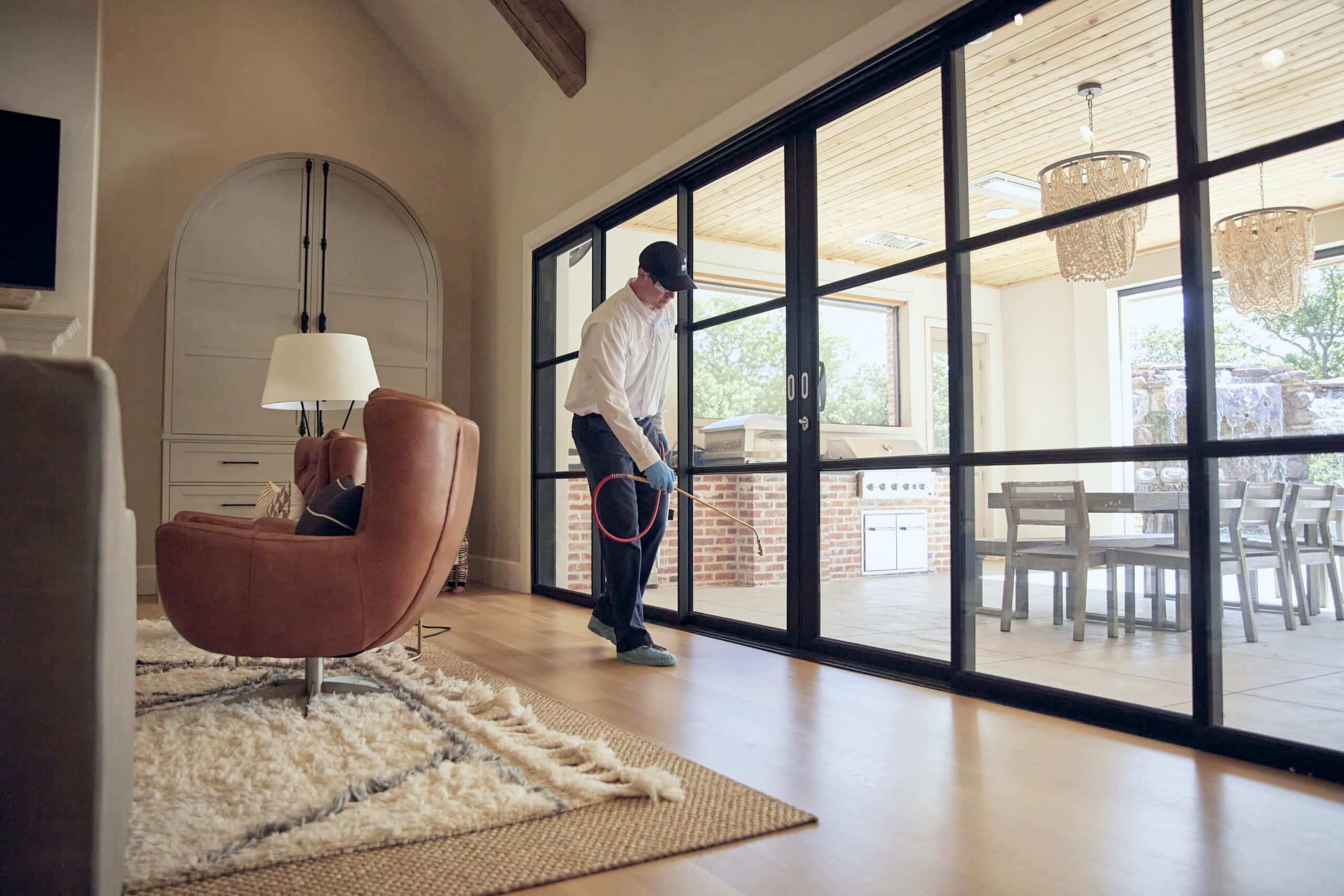 Moxie Pest Control certified field expert applies treatment indoors.