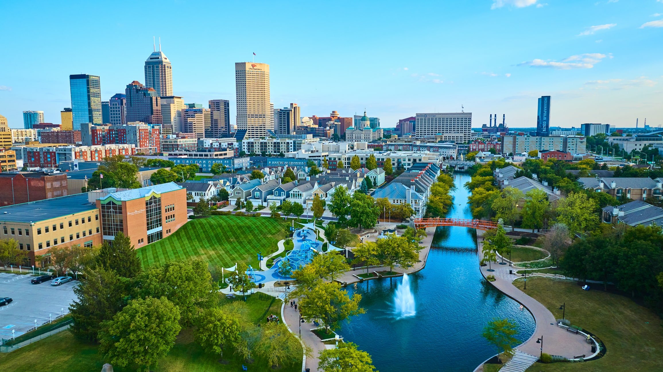 Aerial View of Vibrant Indianapolis Cityscape with Serene Park and Waterway at Golden Hour