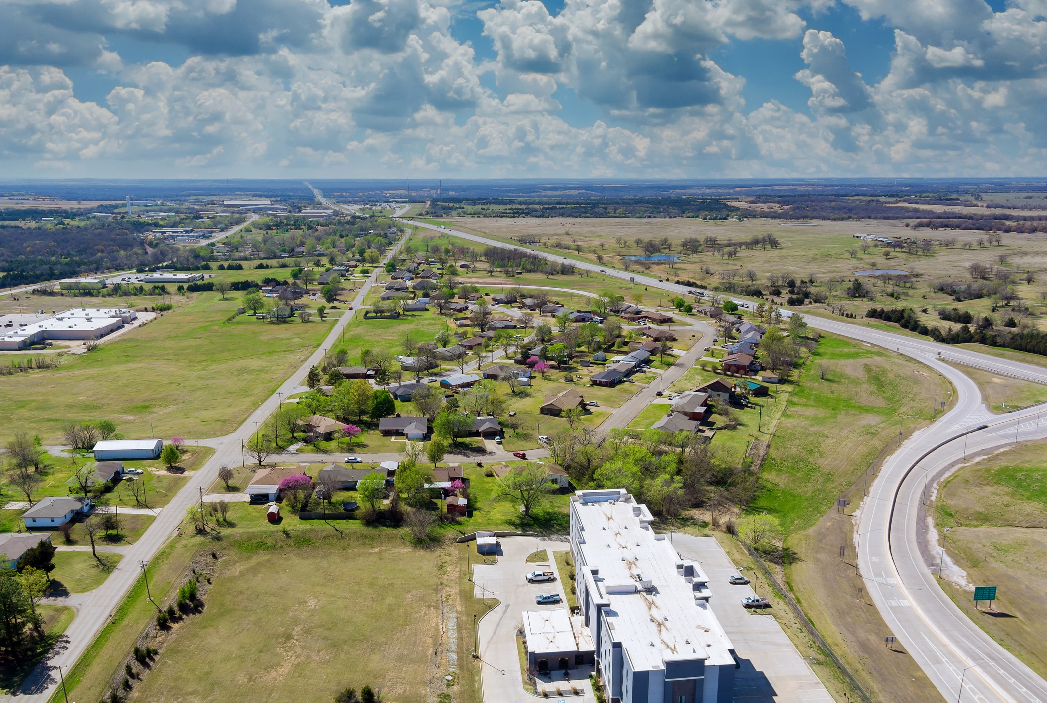 Above transport junction road aerial view with car movement transport industry near residential district in Oklahoma