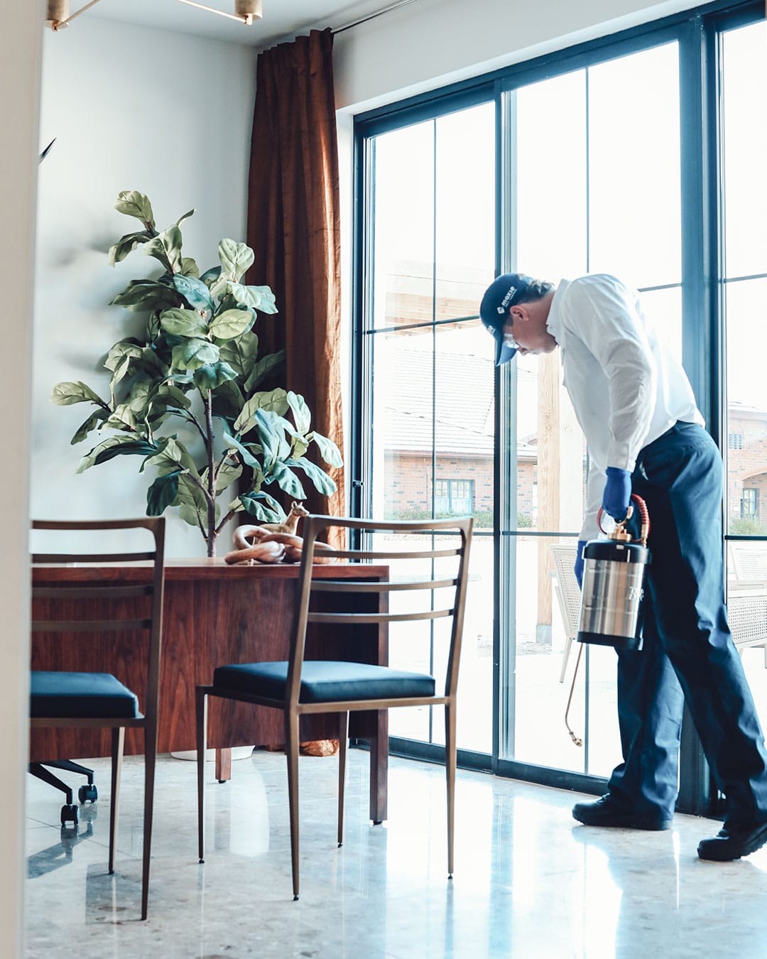Moxie Pest Control Field Expert treats a home for pests